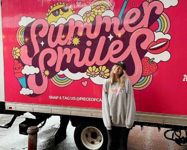 Smiling customer next to Summer Smiles truck - Free Ice Creams by Piece of Cake Moving