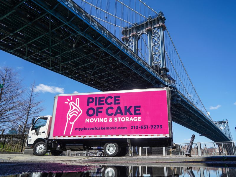 Piece of Cake Moving & Storage - moving truck below Manhattan bridge